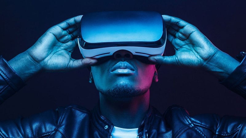 Man holding virtual reality device placed over his eyes